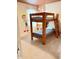 A bunk bed with sturdy wood frame sits in a bedroom with cartoon-themed wall decor at 2386 Rama Dr, Kissimmee, FL 34746