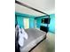 Blue themed bedroom with canopy bed, tv, carpet and direct access to a bathroom at 2386 Rama Dr, Kissimmee, FL 34746