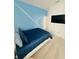 Well-lit bedroom with sleek design and a flat-screen TV on the wall and blue accent wall at 2386 Rama Dr, Kissimmee, FL 34746