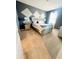 Cozy bedroom with diamond accent wall, carpet flooring, and decorative lamps on each bedside table at 2386 Rama Dr, Kissimmee, FL 34746