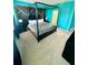 Stylish bedroom featuring a four-poster bed, accent wall, carpet, and modern decor at 2386 Rama Dr, Kissimmee, FL 34746