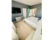 Spacious bedroom with a TV, dresser, carpet, and access to a bathroom at 2386 Rama Dr, Kissimmee, FL 34746