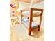 A bunk bed with sturdy wood frame sits in a bedroom with cartoon-themed wall decor at 2386 Rama Dr, Kissimmee, FL 34746