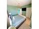 Green bedroom with decorative light fixture, carpet, and access to a bathroom at 2386 Rama Dr, Kissimmee, FL 34746