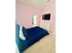 Stylish bedroom with bright pink walls, a full-sized bed and flat-screen TV at 2386 Rama Dr, Kissimmee, FL 34746