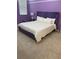 Bedroom boasts a large bed with a purple headboard and neutral carpet at 2386 Rama Dr, Kissimmee, FL 34746