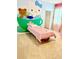 A bedroom with a single bed and cartoon-themed wall decor and pink accents at 2386 Rama Dr, Kissimmee, FL 34746