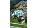 Aerial of the community pool featuring ample seating, a splash pad, and tropical landscaping at 2386 Rama Dr, Kissimmee, FL 34746