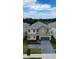 Charming two-story home features a paver driveway, manicured lawn, and a blue two-car garage at 2386 Rama Dr, Kissimmee, FL 34746