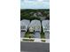 Aerial view of the two-story home showcasing its manicured lawn, blue garage, and neighborhood setting at 2386 Rama Dr, Kissimmee, FL 34746