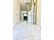 Bright hallway with marble tile flooring and view of other rooms at 2386 Rama Dr, Kissimmee, FL 34746