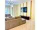 Contemporary living room with plush sectional sofa, TV, and modern decor accents at 2386 Rama Dr, Kissimmee, FL 34746