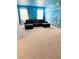 Spacious living room with a comfortable dark blue sectional and colorful mural at 2386 Rama Dr, Kissimmee, FL 34746