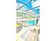 Outdoor pool with screened enclosure, featuring a spa and patio furniture for relaxation and entertaining at 2386 Rama Dr, Kissimmee, FL 34746