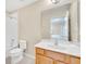 Bright bathroom featuring a vanity with a large mirror, a toilet and a bathtub with shower at 2630 Tranquility Way, Kissimmee, FL 34746