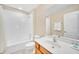 Clean bathroom with tub, shower, vanity, and a toilet with a white shower curtain at 2630 Tranquility Way, Kissimmee, FL 34746