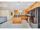 Spacious kitchen with stainless steel appliances, wood cabinets, granite counters, and a center island at 2630 Tranquility Way, Kissimmee, FL 34746