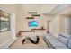 Cozy living room featuring a comfortable sofa, stylish decor, and view through the window to the backyard at 2630 Tranquility Way, Kissimmee, FL 34746
