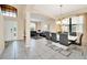 Open-concept living and dining space with tile floors, neutral colors, and plenty of natural light at 2630 Tranquility Way, Kissimmee, FL 34746