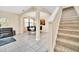 Bright living and dining area with tile flooring, modern furniture, and a staircase to the upper level at 2630 Tranquility Way, Kissimmee, FL 34746