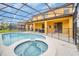 Stunning pool and hot tub featuring an enclosed lanai with patio seating, and sunny backyard at 2630 Tranquility Way, Kissimmee, FL 34746
