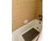 Clean bathtub with tile surround and a shower with a non-slip mat for safety and relaxation at 265 E Canton Ave # Ge, Winter Park, FL 32789