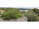 Scenic view of a lake, framed by lush greenery and residential rooftops on a bright day at 265 E Canton Ave # Ge, Winter Park, FL 32789