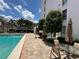 Inviting community pool area with lounge seating, mature landscaping, and sunny skies at 265 E Canton Ave # Ge, Winter Park, FL 32789