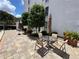Relaxing community pool area with outdoor seating and an umbrella for shade at 265 E Canton Ave # Ge, Winter Park, FL 32789