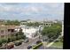 An elevated shot of a charming streetscape featuring unique architecture and mature trees under a bright cloudy sky at 265 E Canton Ave # Ge, Winter Park, FL 32789
