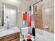 Bathroom featuring a sink with vanity, a toilet, and a shower-tub combo with colorful shower curtain at 2736 Oakwater Dr, Kissimmee, FL 34747