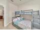 Bedroom with gray bunk beds, neutral walls and bedding, and tile floor at 2736 Oakwater Dr, Kissimmee, FL 34747