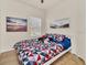 Bedroom with neutral walls, a window with blinds, and decoratively themed bedding and wall art at 2736 Oakwater Dr, Kissimmee, FL 34747