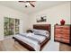 Serene bedroom with a ceiling fan, a sliding glass door, and view at 2736 Oakwater Dr, Kissimmee, FL 34747