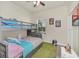 Bedroom featuring a bunk bed with bright bedding, and a large window providing ample natural light at 2736 Oakwater Dr, Kissimmee, FL 34747