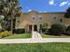 Charming condo with lush landscaping, sidewalk, and a well-maintained exterior, offering a welcoming curb appeal at 2736 Oakwater Dr, Kissimmee, FL 34747