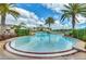 Community pool with lounge chairs and lush tropical landscaping at 2736 Oakwater Dr, Kissimmee, FL 34747