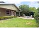 Charming backyard with a seating area, green lawn, and mature landscaping at 2810 Elizabeth Ave, Orlando, FL 32804