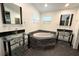 Bathroom with glass bowl sinks, a large soaking tub, and dark tile flooring at 2810 Elizabeth Ave, Orlando, FL 32804