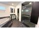 Bathroom featuring glass shower, a soaking tub, and modern fixtures at 2810 Elizabeth Ave, Orlando, FL 32804