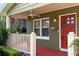 Charming front porch showcases a red door and white railing at 2810 Elizabeth Ave, Orlando, FL 32804