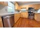 Kitchen featuring wooden cabinets, stainless steel appliances, and hardwood floors at 2810 Elizabeth Ave, Orlando, FL 32804