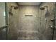 Luxurious shower with pebble stone accent wall, rainfall shower heads, and custom fixtures at 2810 Elizabeth Ave, Orlando, FL 32804