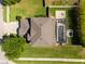 Aerial view of a home with a screened-in pool, a well-manicured lawn, and an extended driveway at 2821 Columbus Ave, Clermont, FL 34715