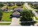 Aerial view of a home highlighting its landscaped yard, and a three car driveway at 2821 Columbus Ave, Clermont, FL 34715