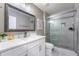 Updated bathroom featuring a white vanity with stone countertop and a glass-enclosed shower at 2821 Columbus Ave, Clermont, FL 34715