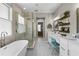 Spacious bathroom featuring a soaking tub, glass shower, double vanity, and decorative tile floor at 2821 Columbus Ave, Clermont, FL 34715