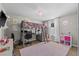 Bright bedroom with loft bed, desk area, and pink rug at 2821 Columbus Ave, Clermont, FL 34715