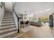 Open-concept entry featuring a staircase, modern light fixture, dining area and spacious living room with lots of light at 2821 Columbus Ave, Clermont, FL 34715
