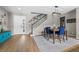 Welcoming foyer with front door, staircase, dining area, modern light fixture and wood-look floors at 2821 Columbus Ave, Clermont, FL 34715